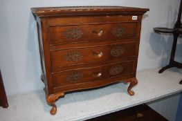 A small Oriental carved three drawer chest