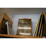 A shelf of framed pictures, mirror etc.