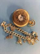 A gold plated half hunter pocket watch and a silver charm bracelet