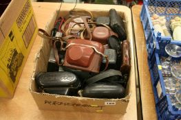 A box of cameras and cases, Kodak, Zenith etc.