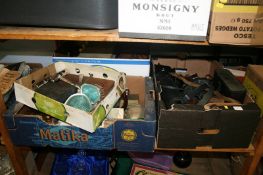 A shelf of miscellaneous, including a box of cameras and cases