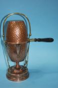 An Arts and Crafts hammered copper coffee pot by Meret and Helong Fourier, 35cm tall