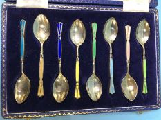 A cased set of enamelled silver tea spoons