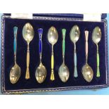 A cased set of enamelled silver tea spoons