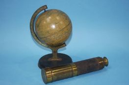 A three drawer telescope and a globe on stand