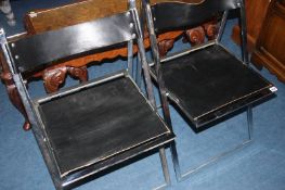 A pair of Elios chrome and leather folding chairs