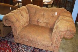 A large button back love seat