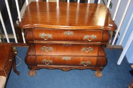 An oak three drawer bombe chest