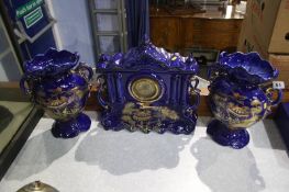 A pottery clock and garniture