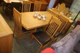 A pale oak dining table with six chairs