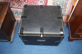 A small leather and studded trunk