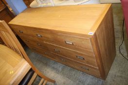 A pale oak seven drawer chest of drawers