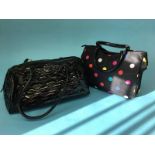 Black patent handbag from Lulu Guinness, with black and beige striped lining and a Lulu by Lulu