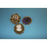 A Victorian mourning brooch, mounted in blue enamel, a swivel mourning brooch and a cameo brooch (