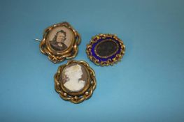 A Victorian mourning brooch, mounted in blue enamel, a swivel mourning brooch and a cameo brooch (