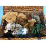 A picnic basket full of eight various bears