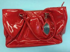 Red patent handbag from Lulu Guiness, with lip lining, with dust bag