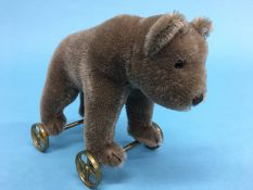 A small Steiff brown bear on wheels