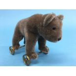 A small Steiff brown bear on wheels