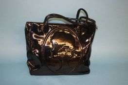 Large black patent handbag with head motif and striped lining, with dust bag