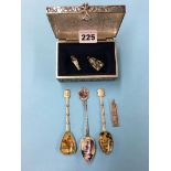 A silver coloured and enamelled propelling pencil, three enamelled spoons etc.
