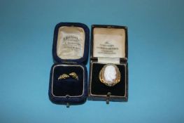 A 9ct gold (stamped 375) cameo ring and a yellow metal Egyptian rams head ring