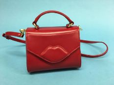 A small red polished leather 'Izzy' Mini Lip crossbody bag, with dust bag