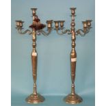 A pair of modern four branch silver coloured candelabra