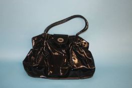 Black patent handbag with red lip lining, with dust bag