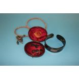 A pair of tortoise shell earrings, mounted with insects, a bangle and a coral necklace, with