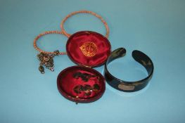 A pair of tortoise shell earrings, mounted with insects, a bangle and a coral necklace, with