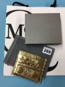 A gold leather card holder by Alexander McQueen, with impressed ID number and original box and bag