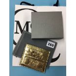 A gold leather card holder by Alexander McQueen, with impressed ID number and original box and bag