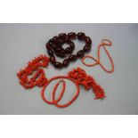 Amber coloured beads and a coral necklace