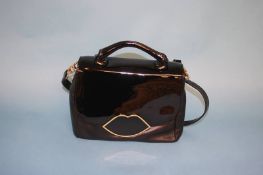 Black 'Poppy' handbag from Lulu Guinness with gold outline Lip fastener