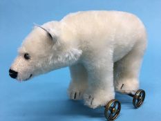 A small Steiff polar bear on wheels