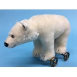 A small Steiff polar bear on wheels