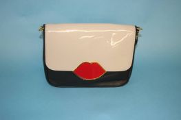 Black and tan bag with 'Lip' fastener from Lulu Guinness, with dust bag