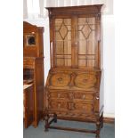 Oak bureau bookcase, upper glazed section enclosing three shelves, bottom section with fall-front en