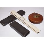 Leather bound tape measure together with slide rul