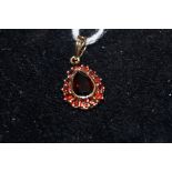 9ct Gold pendant set with central garnets