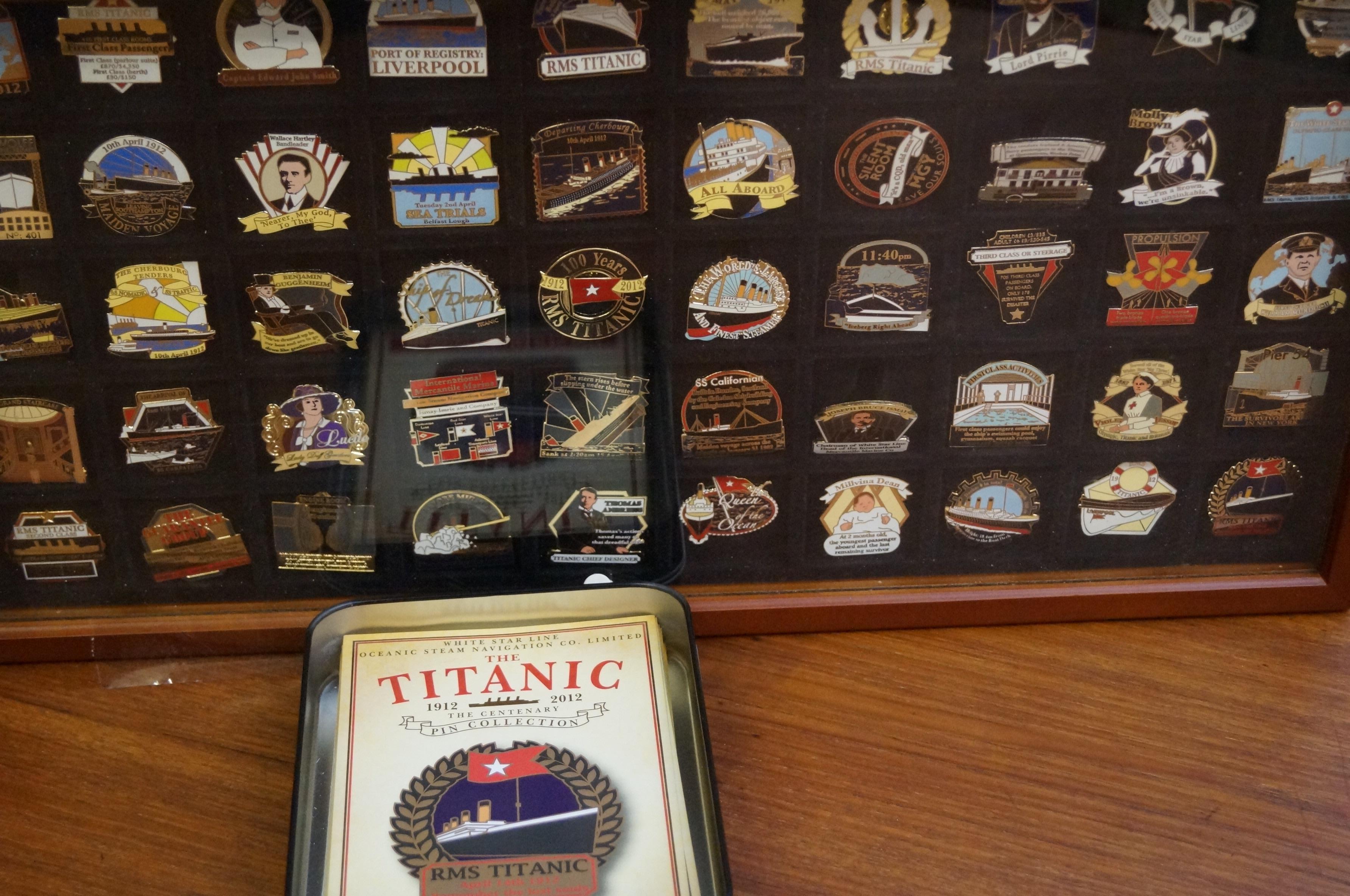 Cased and mounted set of titanic themed badges