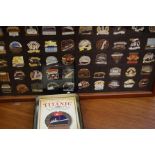 Cased and mounted set of titanic themed badges