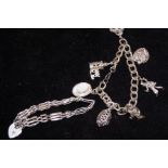 Silver charm bracelet with 7 charms together with