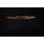 9ct Gold pin brooch set with central amethyst