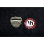 Enamel swastika pin badge together with a dress ri