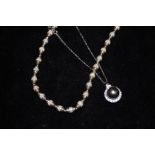 Silver Tahitian pearl necklace together with a sil