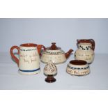 5 items of torquay ware to include a puzzle jug