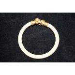 Ivory bangle with rams head terminals