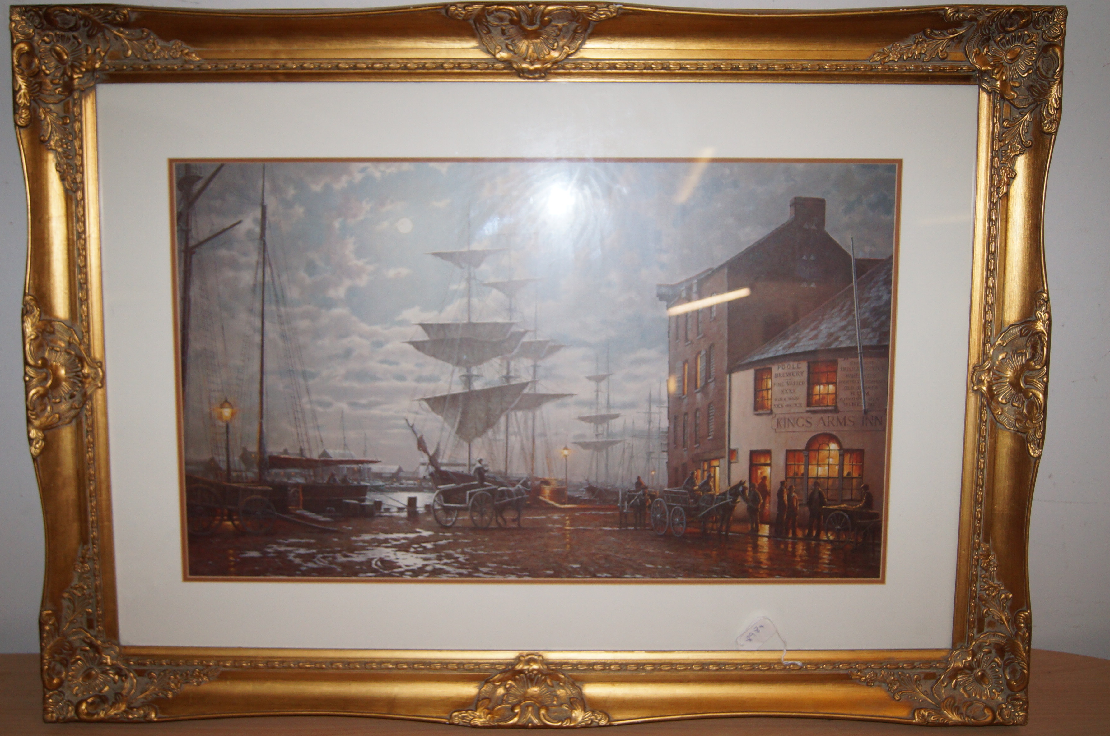 Large gilt framed print depicting dock scene